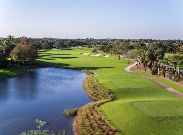 surrounding community featuring a lawn and a water view