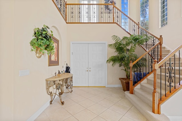 entrance foyer with a high ceiling and tile patterned floors