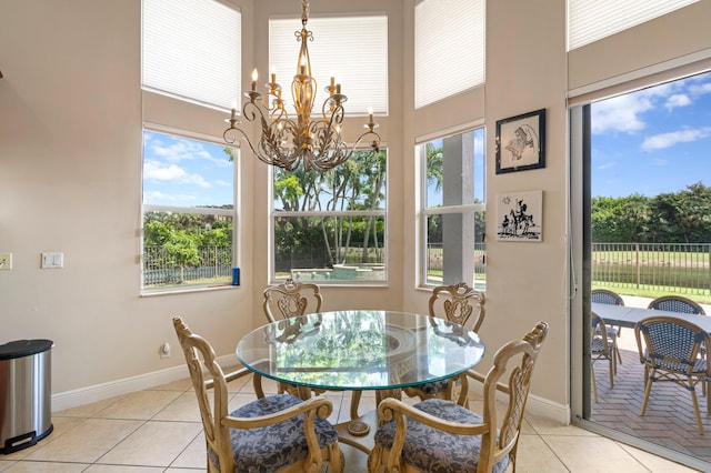 tiled dining area featuring a chandelier and plenty of natural light