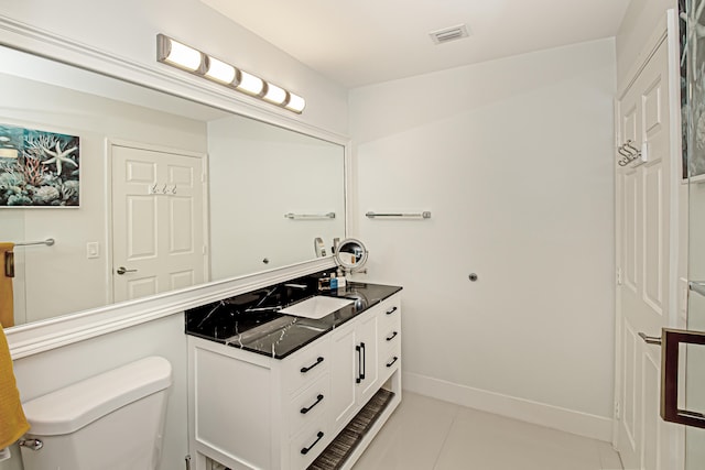 bathroom with tile patterned floors, vanity, and toilet