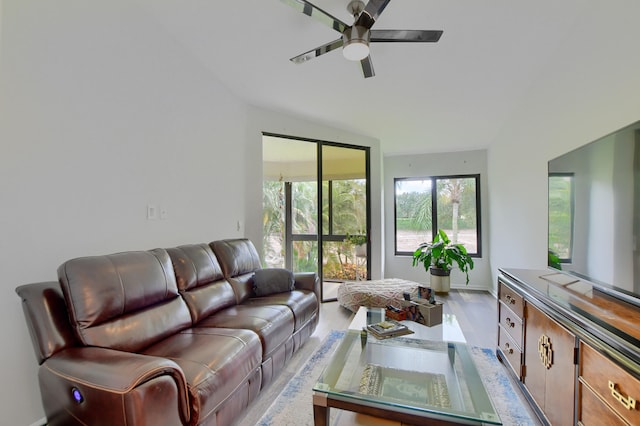 living room with light hardwood / wood-style floors, lofted ceiling, and ceiling fan