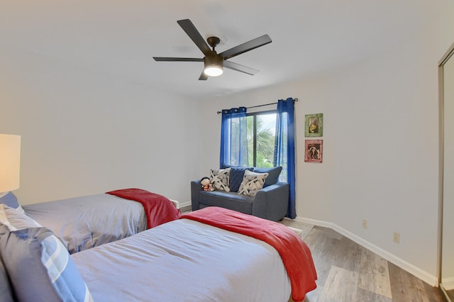 bedroom with light wood-type flooring and ceiling fan