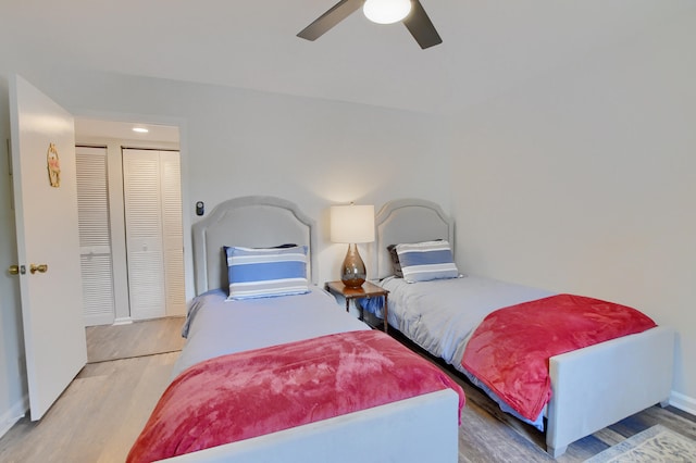 bedroom featuring wood-type flooring, a closet, and ceiling fan