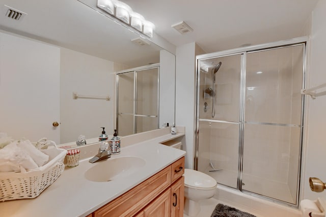 bathroom with toilet, an enclosed shower, vanity, and tile patterned flooring