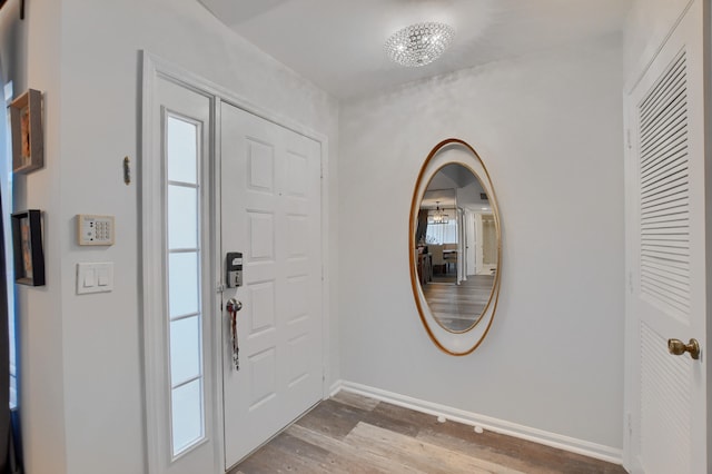 entrance foyer featuring a notable chandelier and hardwood / wood-style floors