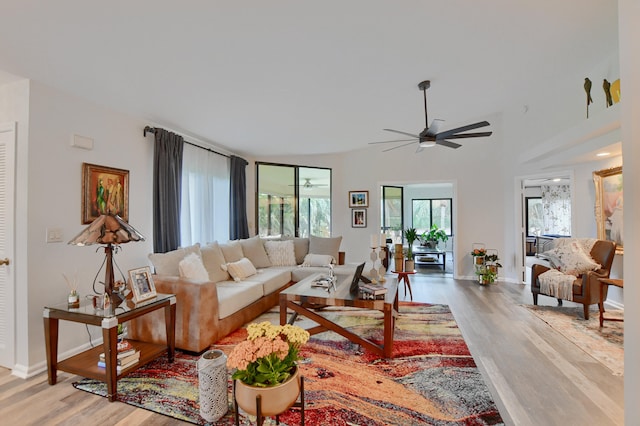 living room featuring ceiling fan and wood-type flooring