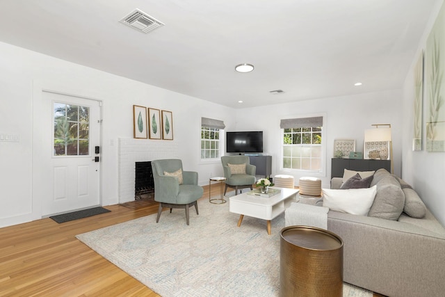 living room with hardwood / wood-style floors and a fireplace