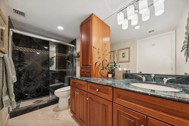 bathroom with vanity, walk in shower, tile patterned flooring, and toilet