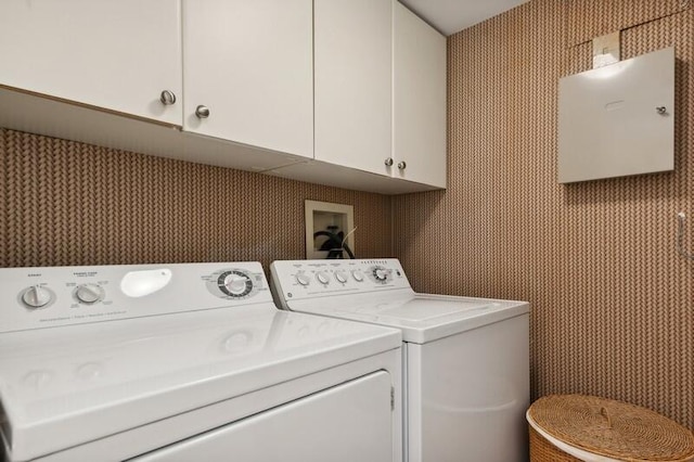 washroom with washer and clothes dryer and cabinets