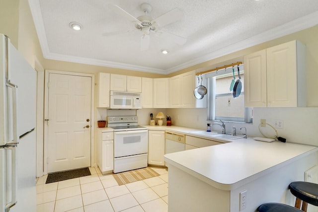 kitchen featuring a kitchen bar, sink, ornamental molding, kitchen peninsula, and white appliances