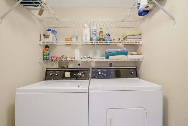 laundry room with washing machine and clothes dryer