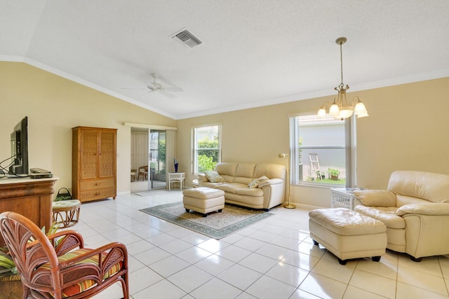 living room with light tile patterned flooring, lofted ceiling, ceiling fan with notable chandelier, and crown molding