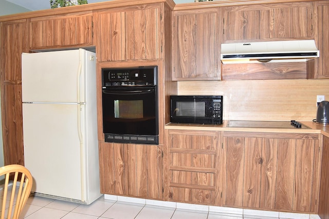 kitchen with light tile patterned floors and black appliances