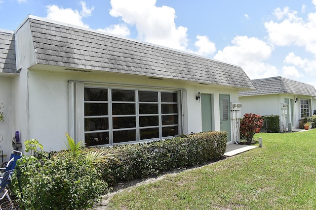 rear view of house featuring a lawn