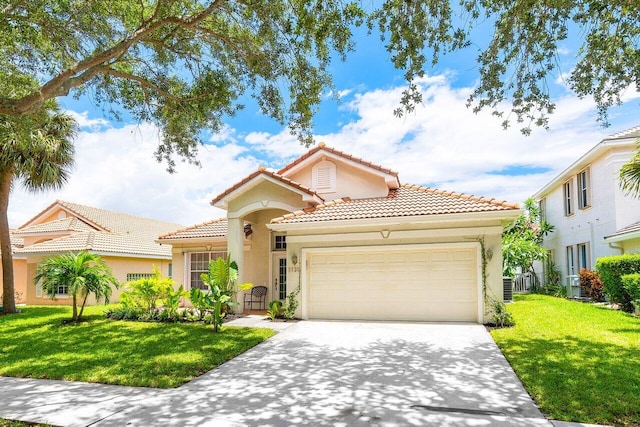 mediterranean / spanish-style home featuring a garage and a front yard