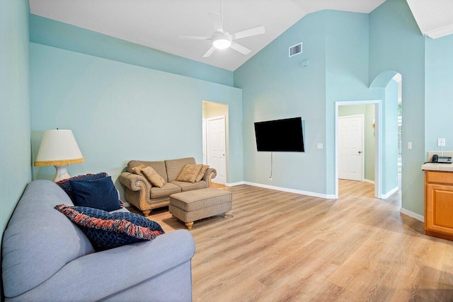 living room featuring ceiling fan, light hardwood / wood-style floors, and high vaulted ceiling