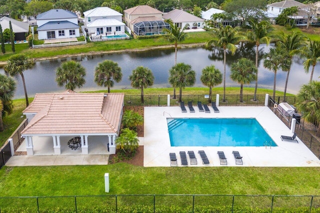 view of pool with a patio area, a yard, and a water view