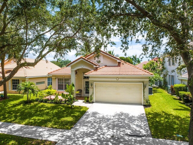 mediterranean / spanish-style home featuring a front lawn, a garage, and central AC