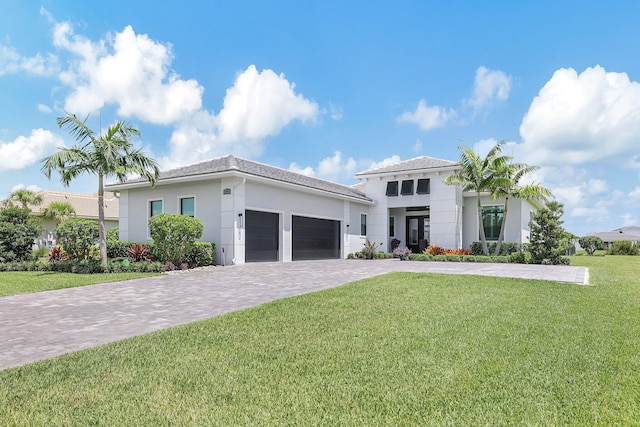 mediterranean / spanish-style house with a garage and a front lawn