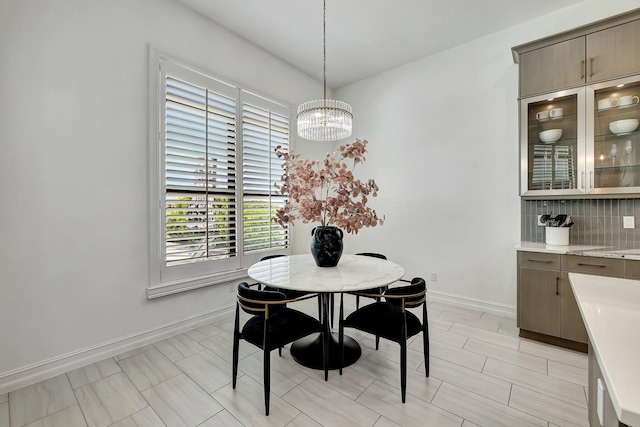 dining space with an inviting chandelier