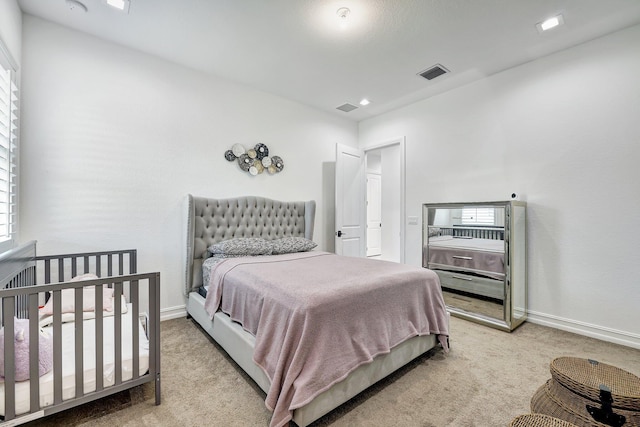 bedroom featuring light carpet