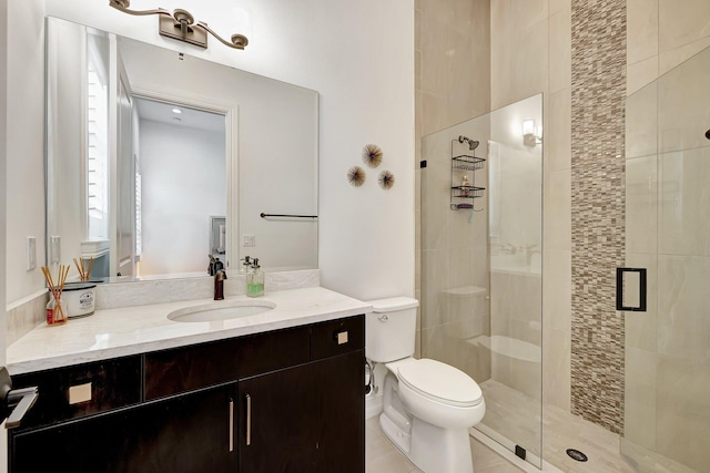 bathroom with tile patterned floors, toilet, an enclosed shower, and vanity