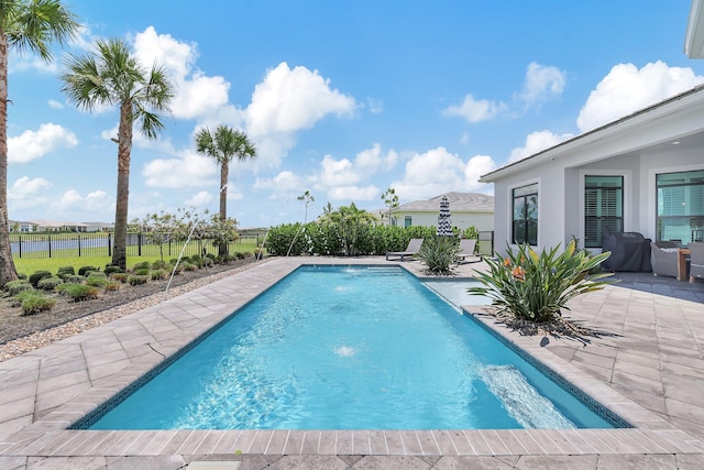 view of pool featuring pool water feature and a patio