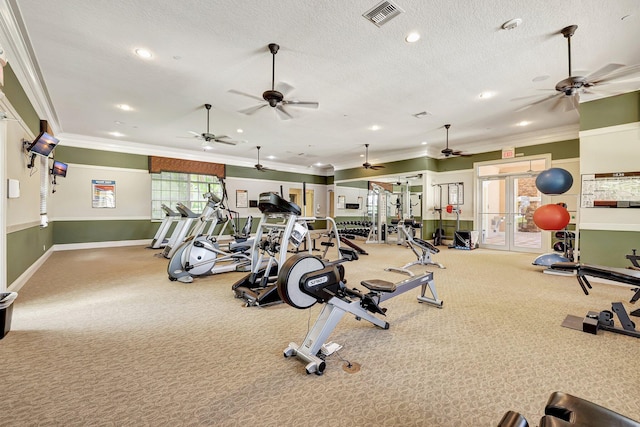 exercise room featuring french doors, a textured ceiling, and ornamental molding