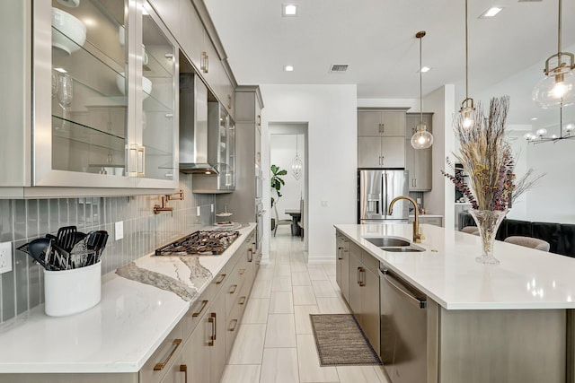 kitchen with a spacious island, sink, hanging light fixtures, gray cabinets, and stainless steel appliances