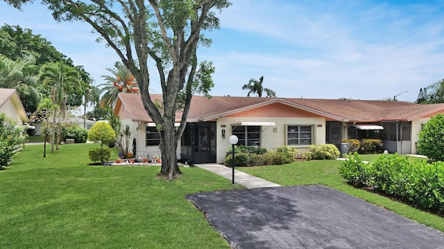 single story home featuring a front lawn