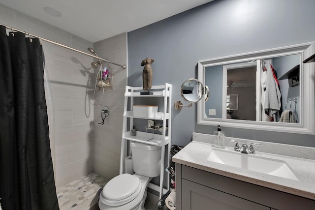 bathroom featuring a shower with shower curtain, vanity, and toilet