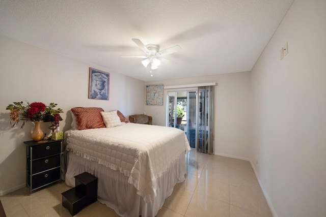 bedroom featuring ceiling fan, light tile patterned flooring, access to exterior, and a textured ceiling