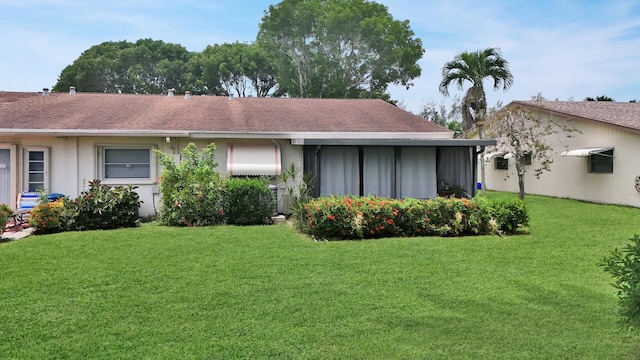 rear view of house featuring a yard