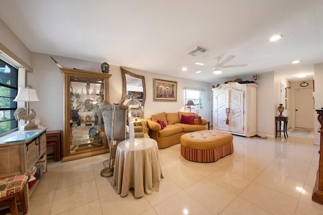 tiled living room with ceiling fan