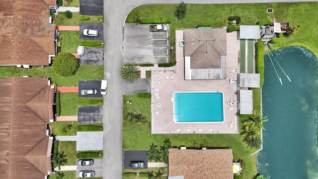 birds eye view of property with a water view