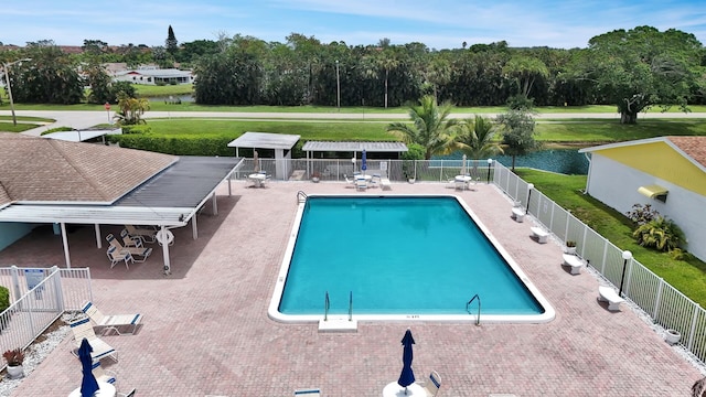 view of swimming pool featuring a water view and a patio