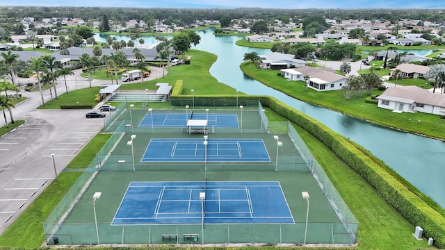 view of tennis court featuring a water view