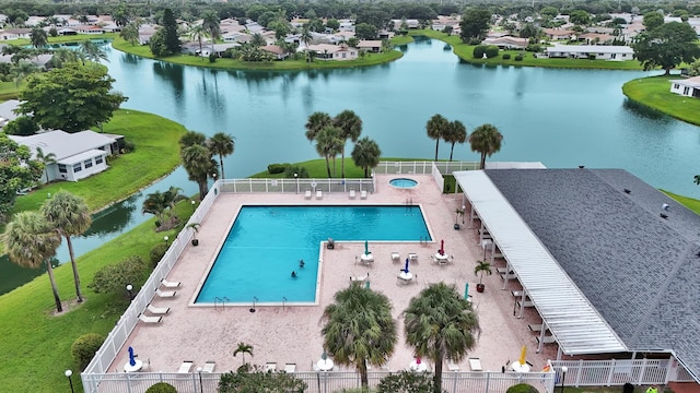 view of swimming pool featuring a water view