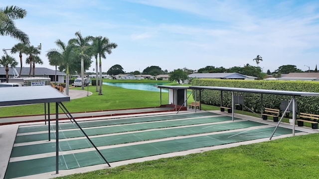 view of community with a yard and a water view