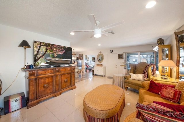 tiled living room featuring ceiling fan and a textured ceiling