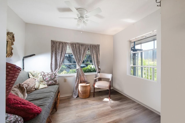 living area with light hardwood / wood-style flooring and ceiling fan