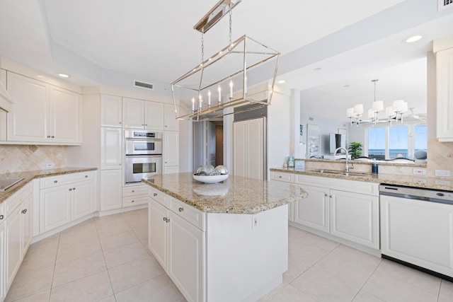 kitchen featuring sink, a kitchen island, double oven, white dishwasher, and white cabinets