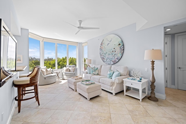 tiled living room with a wall of windows and ceiling fan