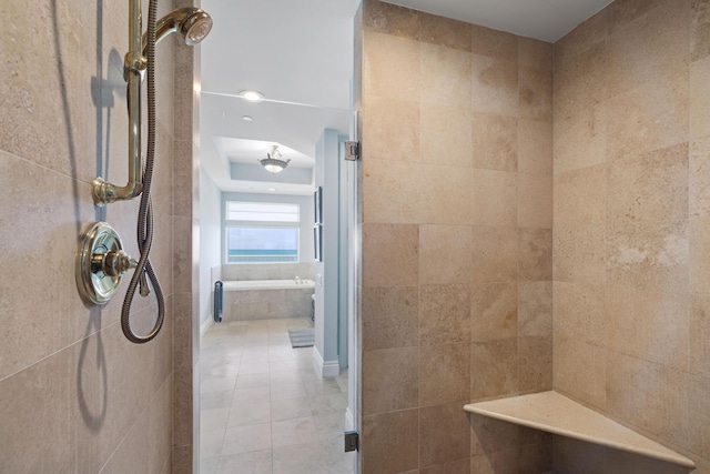 bathroom featuring tile patterned flooring, tile walls, and independent shower and bath