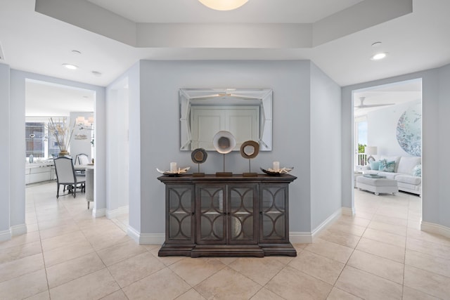 hall featuring light tile patterned floors