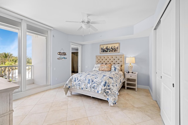 bedroom with light tile patterned floors, a closet, and ceiling fan