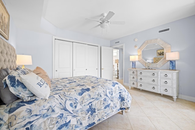 bedroom with ceiling fan, light tile patterned floors, and a closet