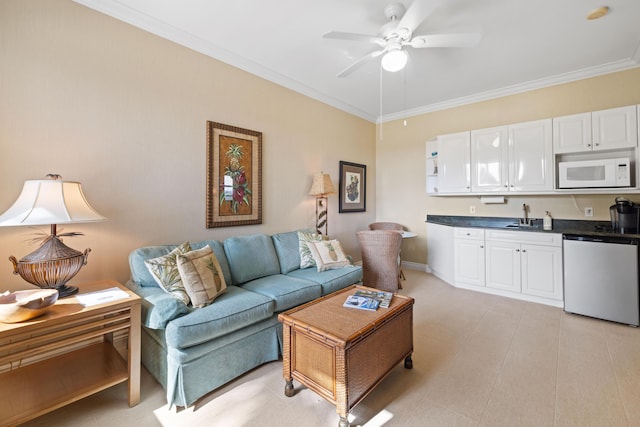 living room featuring light tile patterned floors, ceiling fan, crown molding, and sink