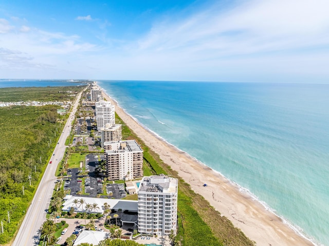 bird's eye view featuring a view of the beach and a water view