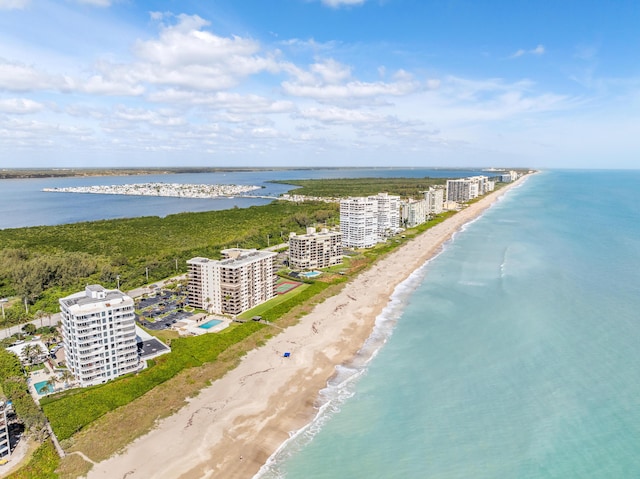 aerial view with a water view and a beach view